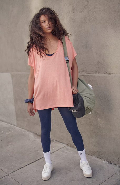 The model is wearing the t-shirt in pink.