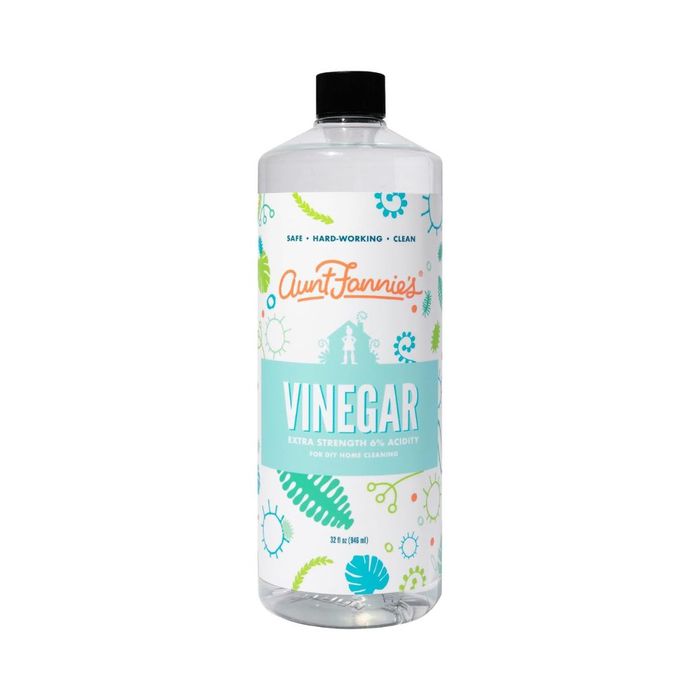 A bottle of Aunt Fannie's Vinegar, marked as "Extra Strength 6% Acidity" for cleaning purposes, featuring a label adorned with leaf motifs and cleaning symbols