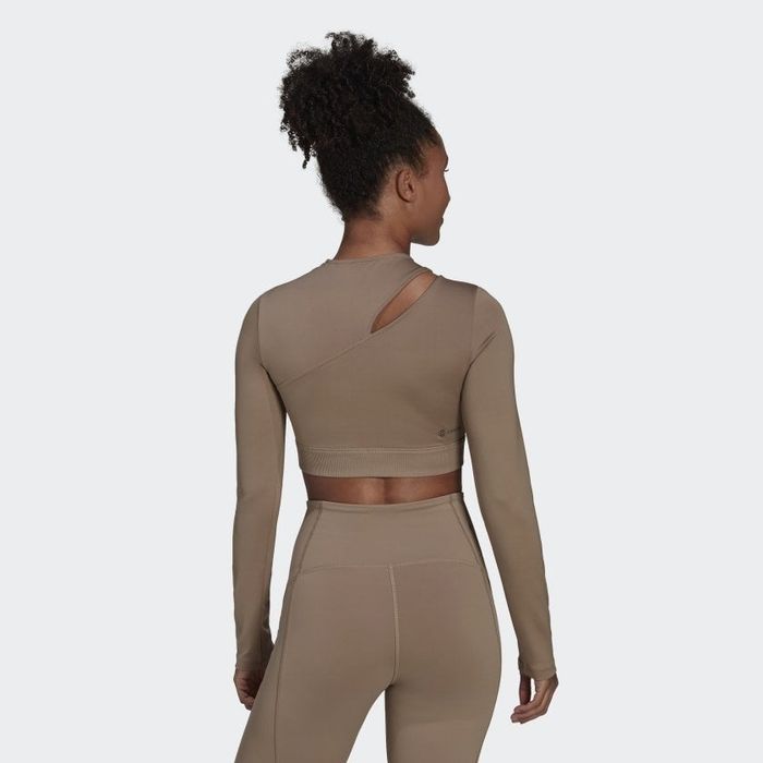 Back view of the model wearing the long sleeve shirt featuring a stylish cutout.