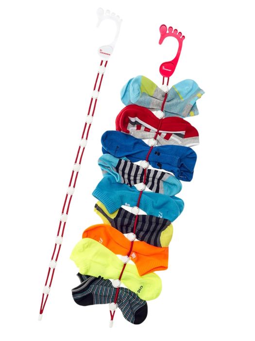 A sock organizer tool displays neatly paired socks on a vertical strip with hooks, ensuring each pair is kept tidy and easily accessible.