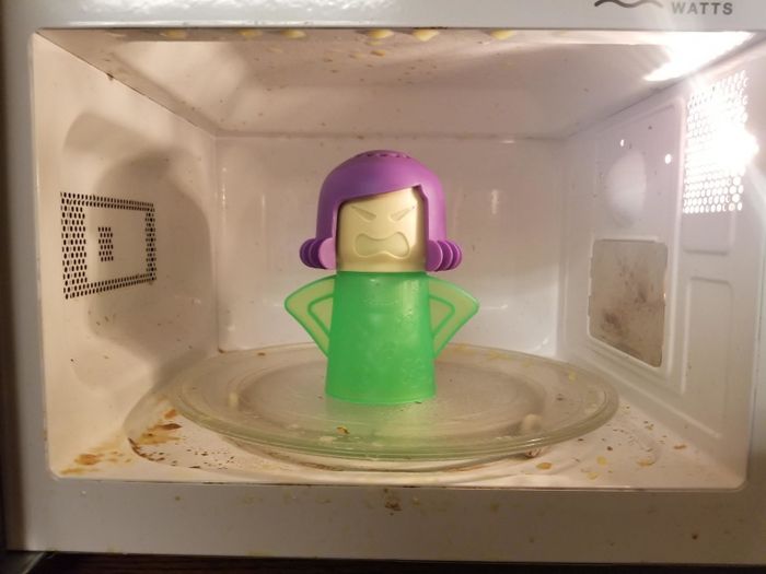 Angry Mama cleaner placed inside a messy microwave