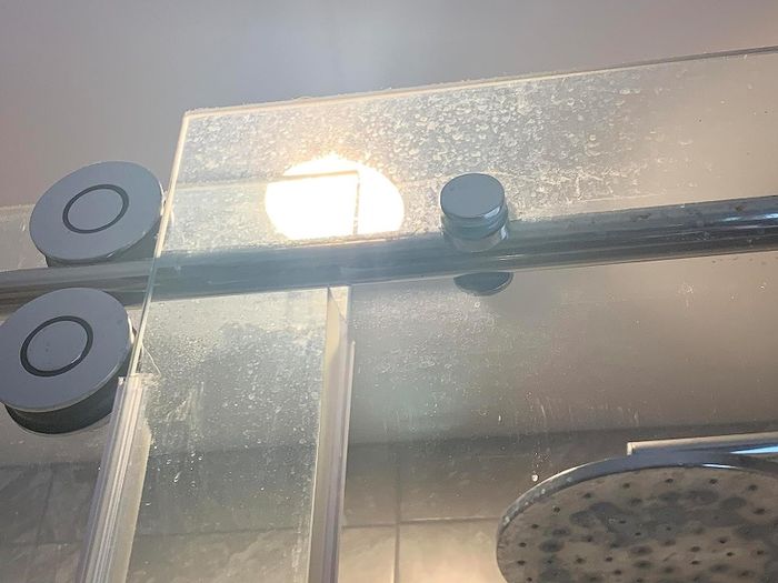 Photo from the reviewer showing their shower before using the cleaner