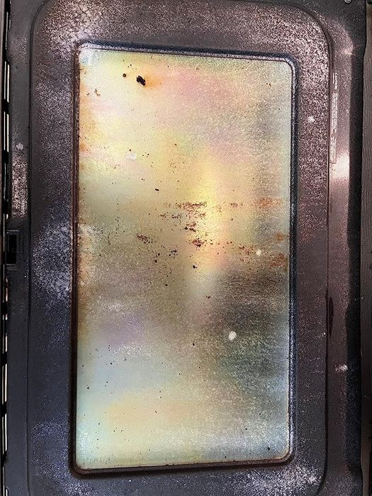 A reviewer’s photo of a dirty oven door