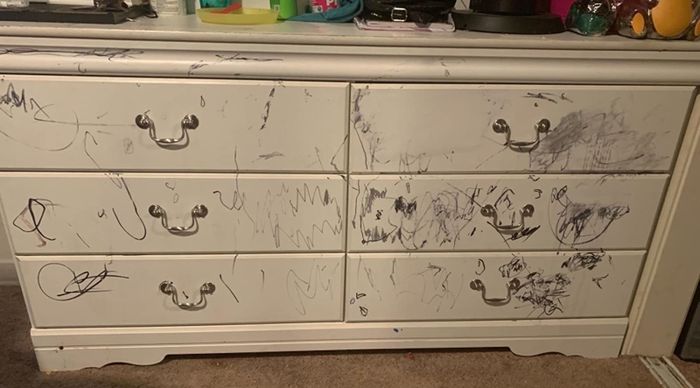 Before image showing a white dresser covered in scribbles from a black permanent marker