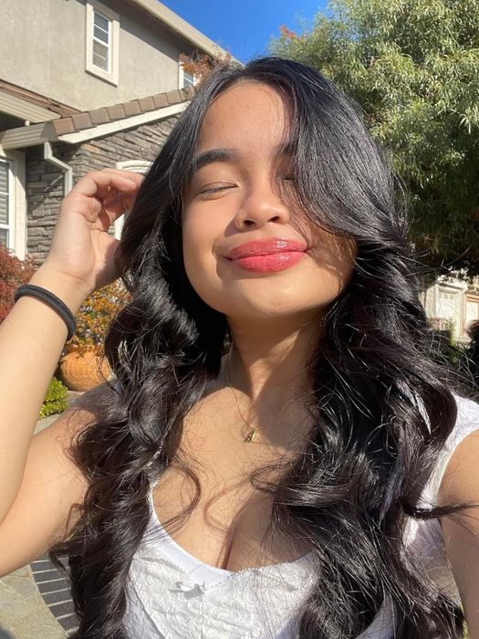 A user with lengthy, wavy locks