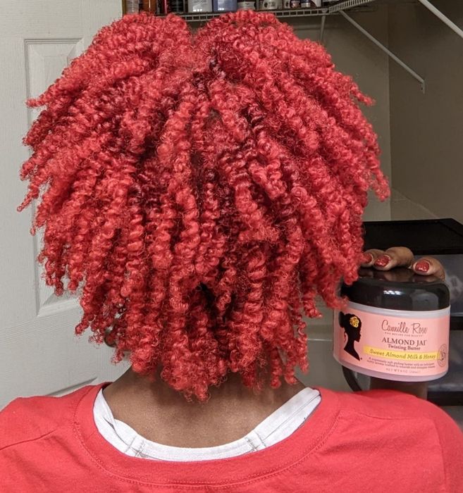A reviewer flaunts her bright red, glossy coils