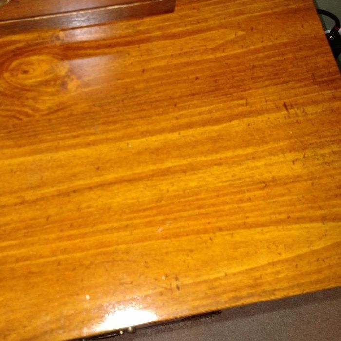 The same wooden table now gleaming with a smooth, even finish and no discoloration in sight.
