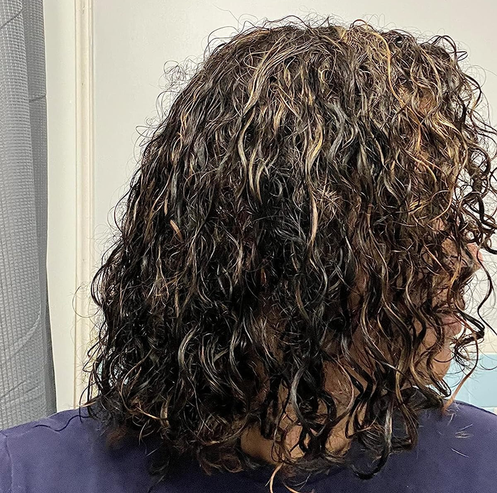 An image of a reviewer with damp, wavy hair before styling.