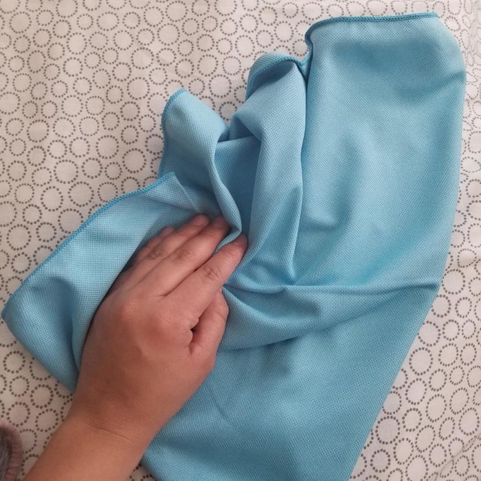 A reviewer cleaning a surface with one of the cloths