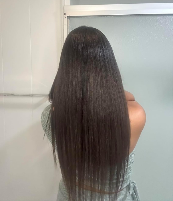 Reviewer with long, straight, and healthy-looking hair