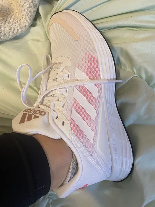 A reviewer wearing Adidas running shoes