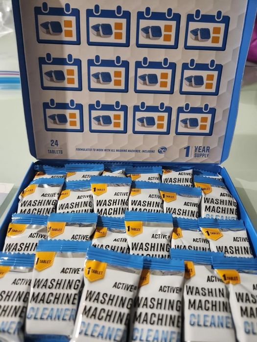 Open box of washing machine cleaner tablets with visible packaging and a label indicating a year's supply