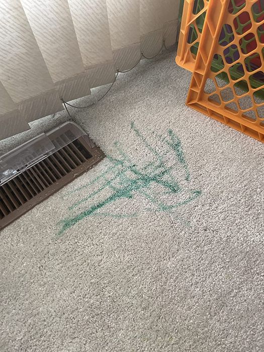 Before image of green marker marks on a beige carpet