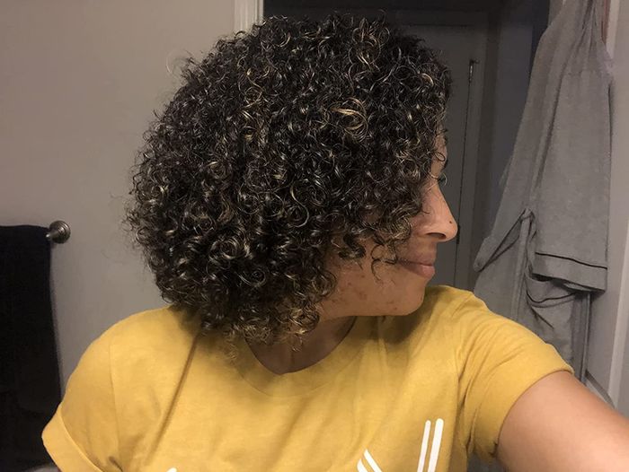 Image of a reviewer with smooth, untangled curly hair