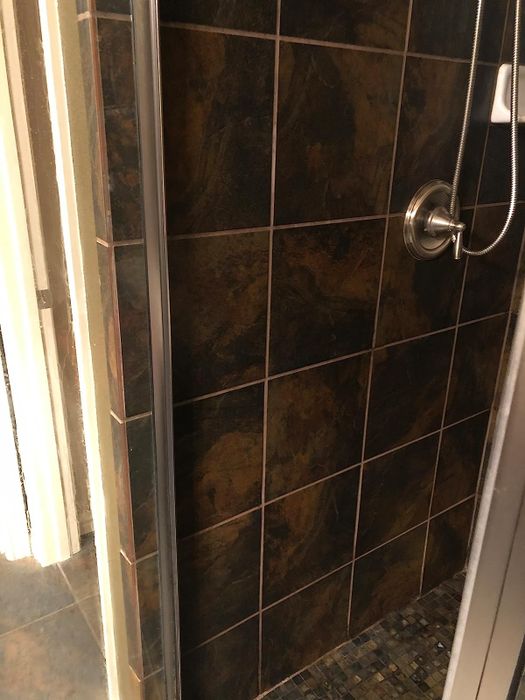 A reviewer’s photo of the same shower wall now looking spotless