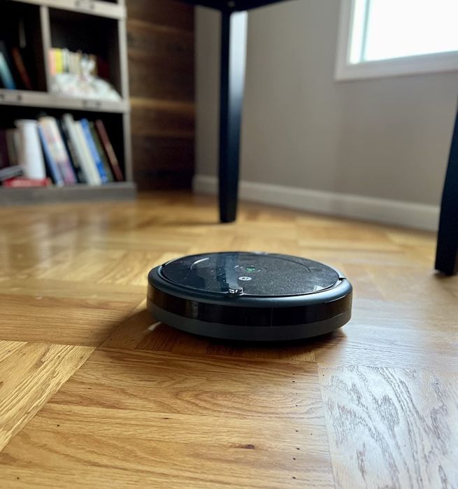 Reviewer image of the Roomba in action on hardwood floors