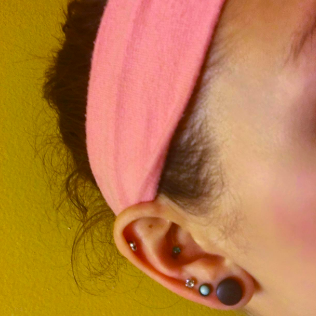 A reviewer with baby hairs along the side of their face near their ear