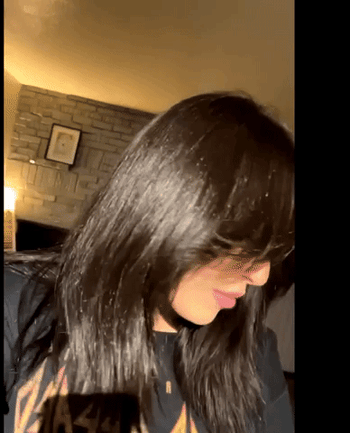 A GIF capturing the reviewer flaunting their long, lustrous locks with a shake.