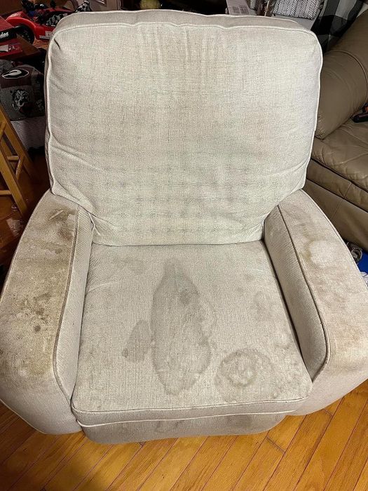 Before image of a heavily stained beige armchair