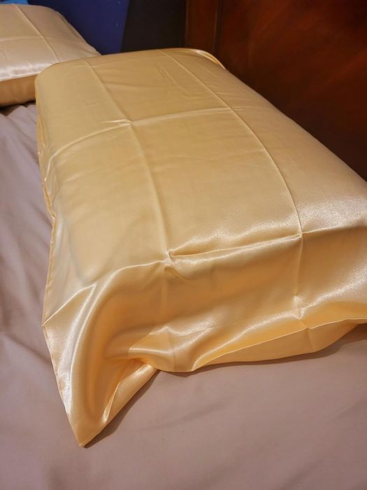 A silky pillowcase displayed neatly on a bed