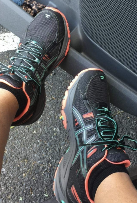 A reviewer wearing Asics Gel Venture sneakers
