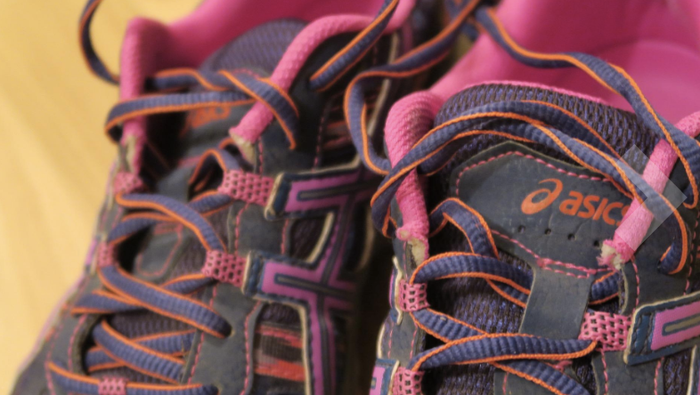A reviewer's Asics Gel Ventures in pink, blue, and coral