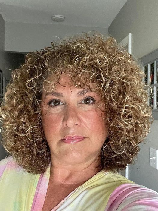 Reviewer shows off shiny, loose curls after using the product