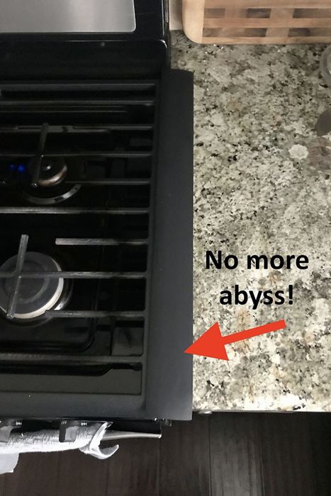 A reviewer’s photo of the same stove now with a gap filler in place, and text that reads