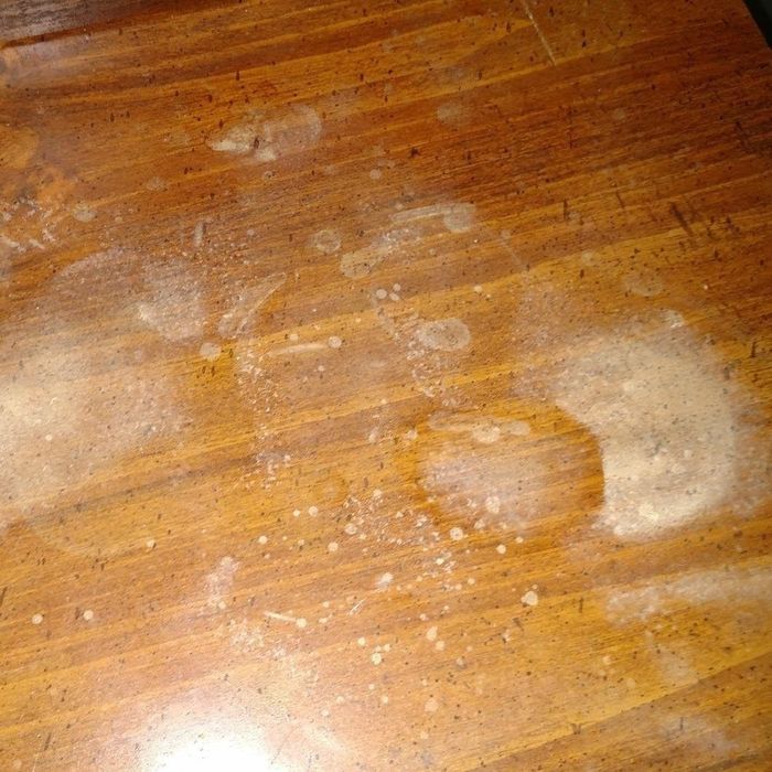 A wooden table with noticeable discoloration.