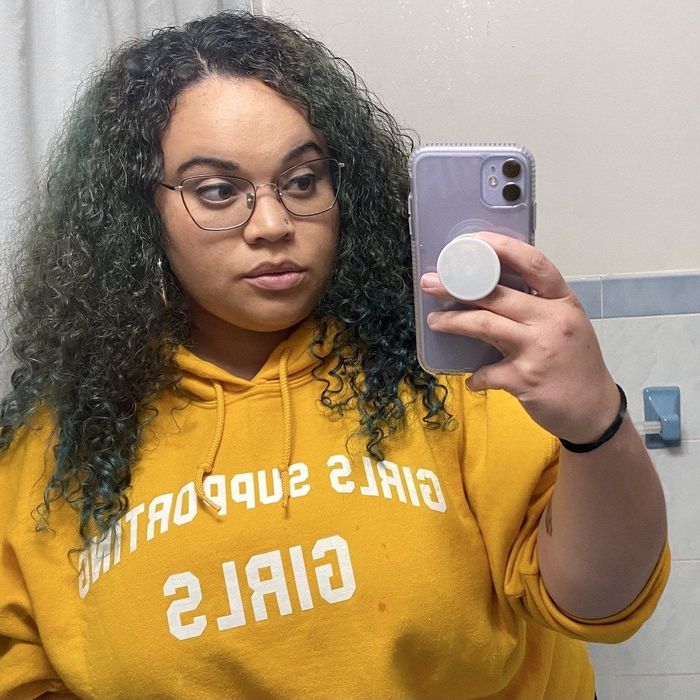 a Mytour shopping editor showcasing her defined curls after applying the product