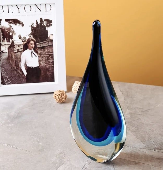 A glass sculpture elegantly displayed on a table