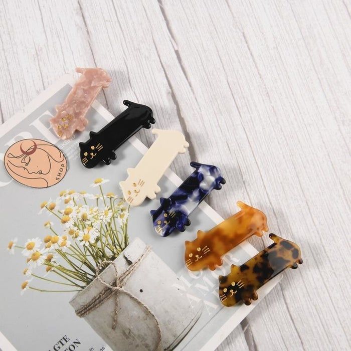 Long cat-shaped barrettes in pink, black, white, marbled blue, light tortoise, and dark tortoise acrylic