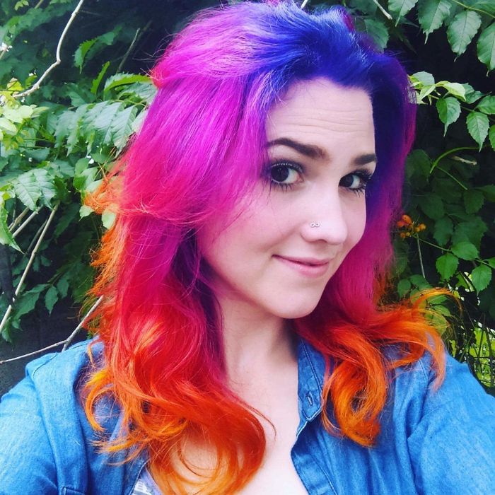 a reviewer rocking vibrant pink, purple, and orange hair