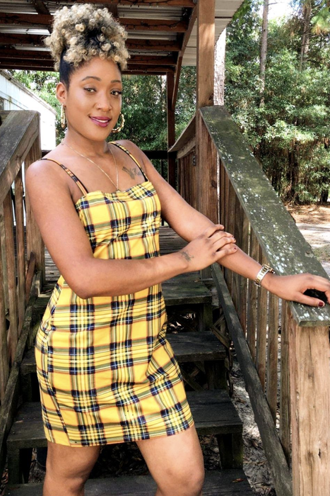 reviewer wearing the plaid dress