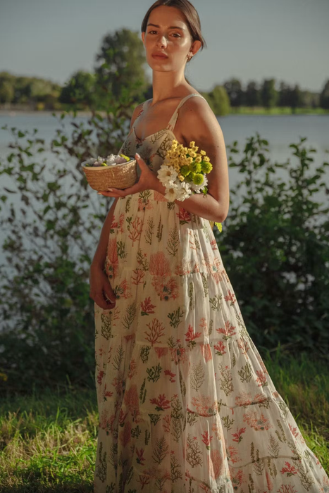 model showcasing a tiered summer dress in a picturesque meadow