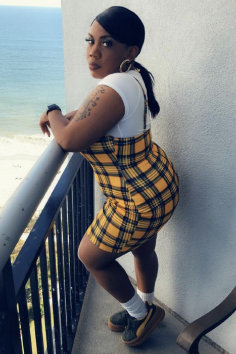 reviewer styling the plaid dress with a white tee layered underneath