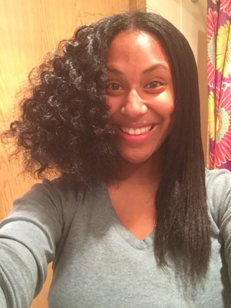A reviewer displaying a progress shot of their hair, half in its natural curls and half straightened
