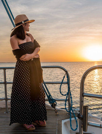 reviewer sporting the two-piece outfit with a shawl while on a boat