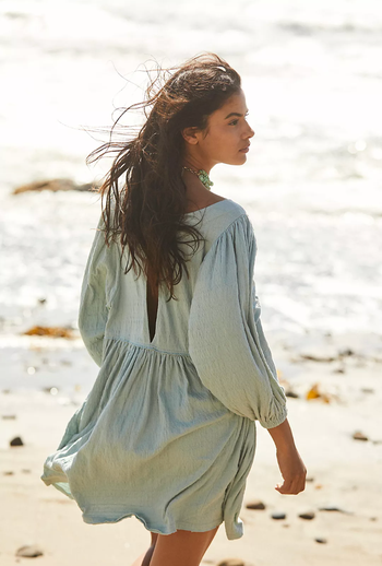 Reviewer in a soft sage green variation of the same dress