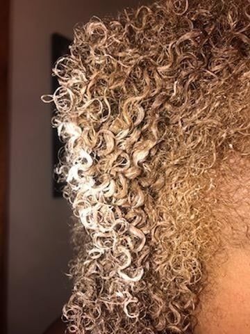 a reviewer photo showcasing their tightly coiled curls