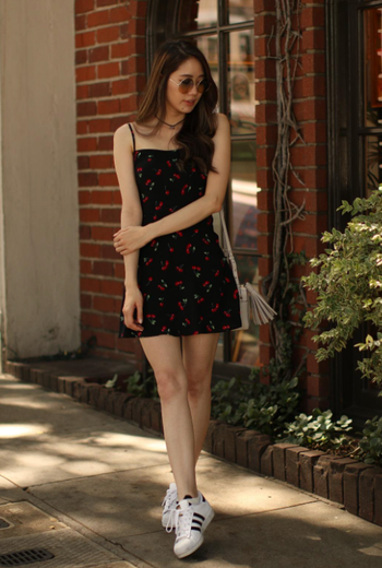 reviewer wearing the dress paired with sneakers