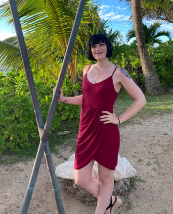 reviewer wearing the dress in a rich wine color