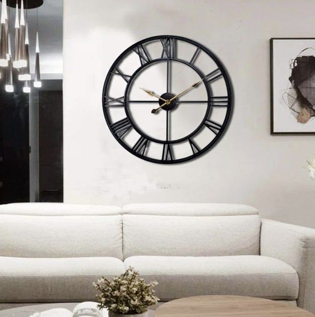 A cozy living room showcasing a large wall clock mounted above a pristine white sofa