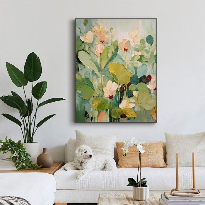 An abstract floral artwork displayed above a couch with cushions, a dog resting on it, and indoor plants nearby