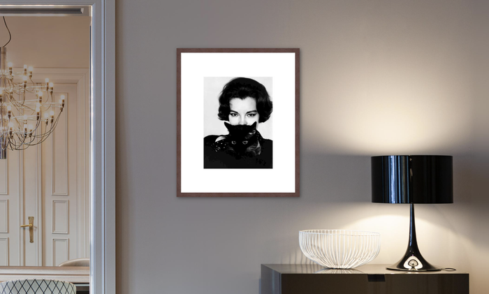 A black and white framed portrait of Audrey Hepburn displayed in a modern living room setting