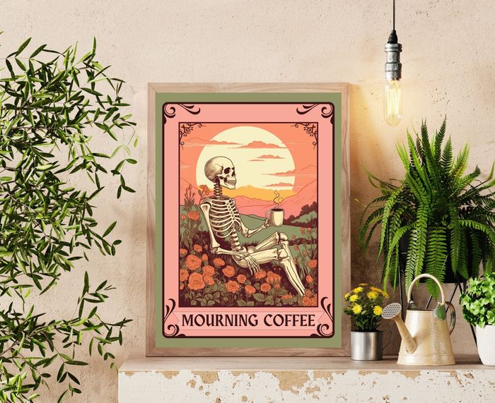 A framed artwork titled "Mourning Coffee," depicting a skeleton lounging with a coffee cup in a garden, displayed in a cozy plant-filled room