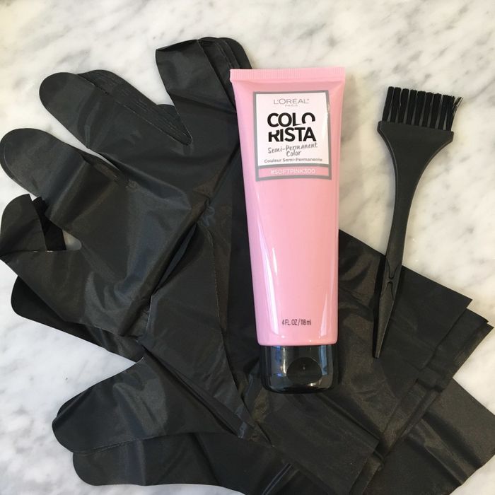 the bottle displayed alongside a brush and gloves