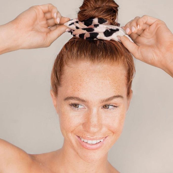 A model sporting a thick leopard scrunchie in a wet bun