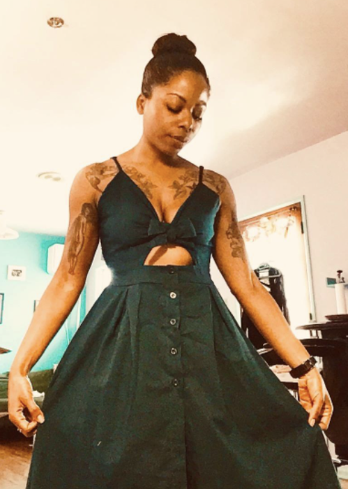 reviewer wearing the dress in a vibrant green shade