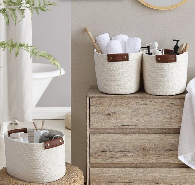 Baskets filled with rolled towels and toiletries, neatly arranged on a dresser